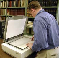 James Sorrell assures proper placement of a document before scanning